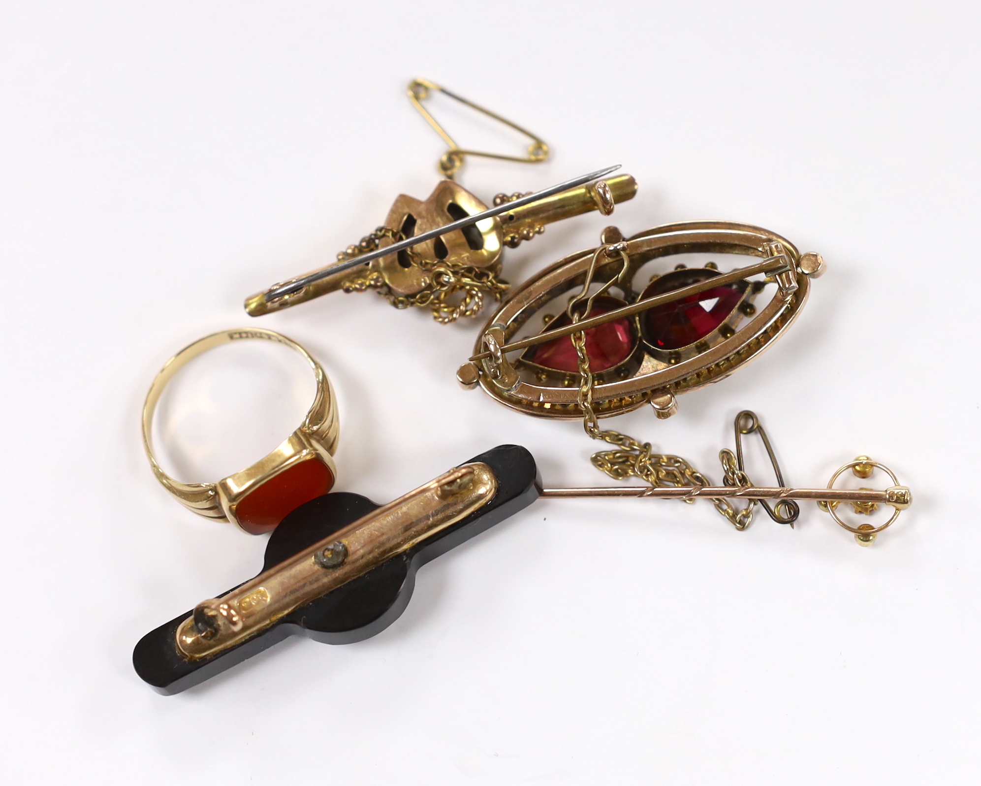 A 14k and carnelian set signet ring, size R/S, 3.1 grams, a Victorian yellow metal, two stone garnet and split pearl cluster set brooch, two other 9ct and gem set bar brooches including twin hearts and a 15ct and gem set
